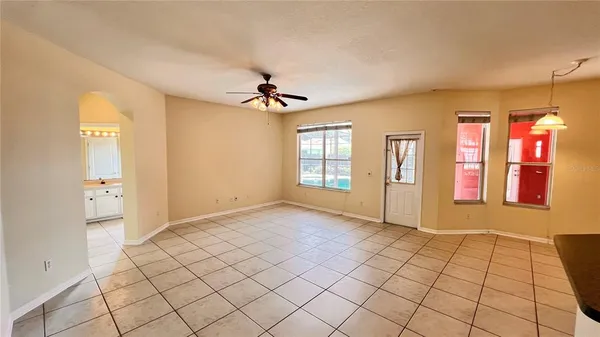 a view of room with a ceiling fan and window
