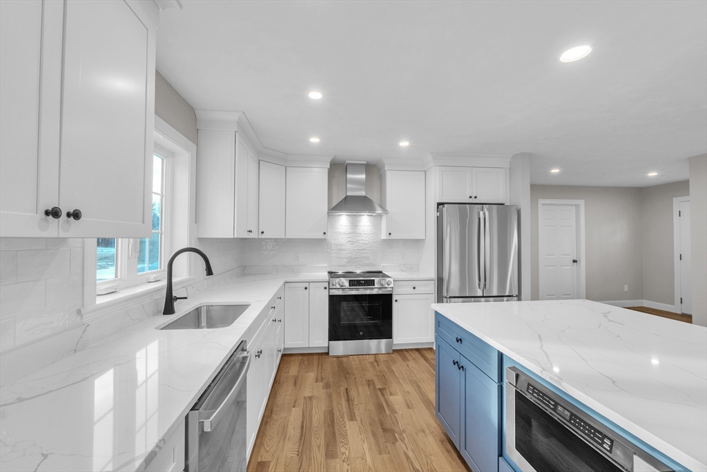 116 Townsend Harbor Road Lunenburg, MA 01462 - Photo 6 of 30 a kitchen with stainless steel appliances granite countertop a sink stove and refrigerator