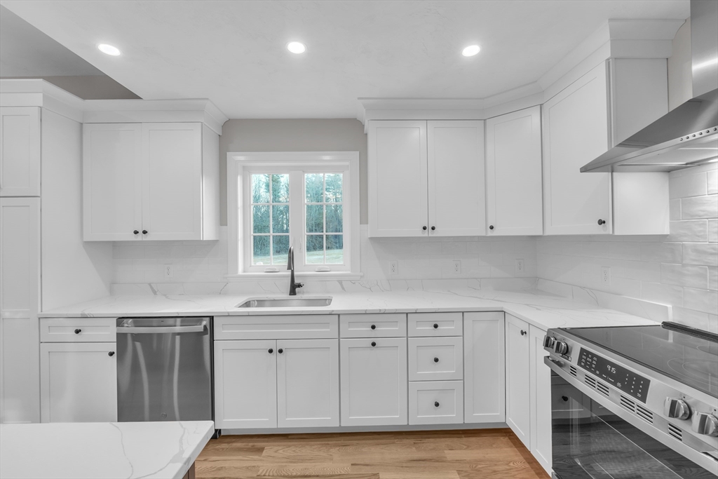 116 Townsend Harbor Road Lunenburg, MA 01462 - Photo 7 of 30 a kitchen with white cabinets stainless steel appliances and sink