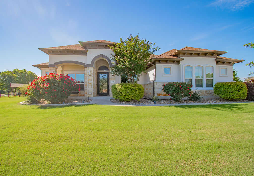 a front view of a house with garden