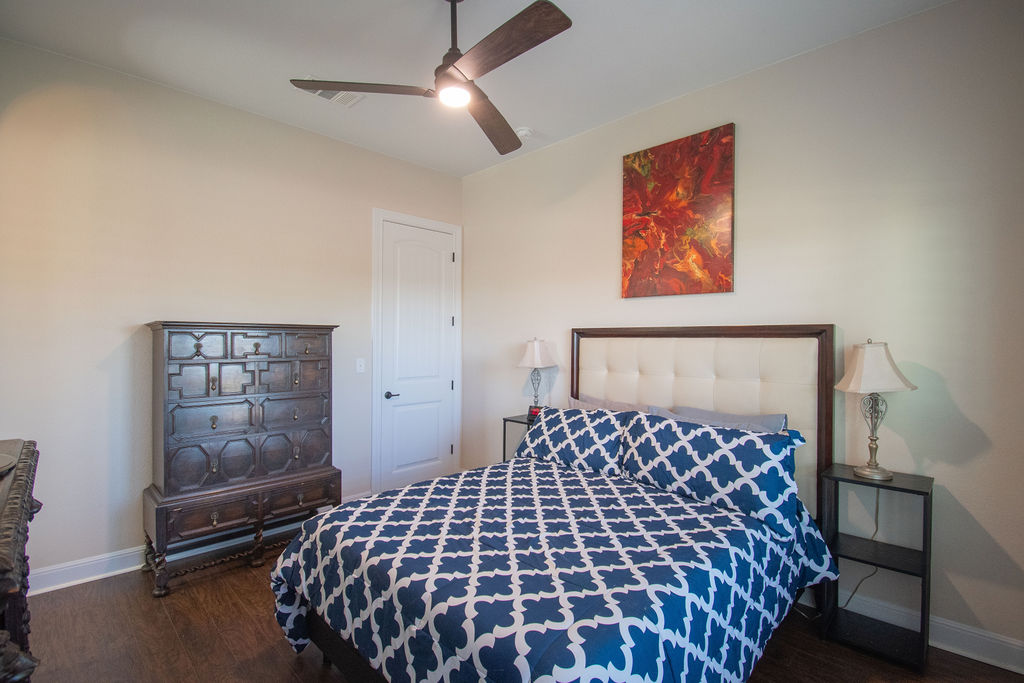 Undisclosed Address Georgetown, TX 78633 - Photo 13 of 39 a large bed in a bedroom next to a cabinet