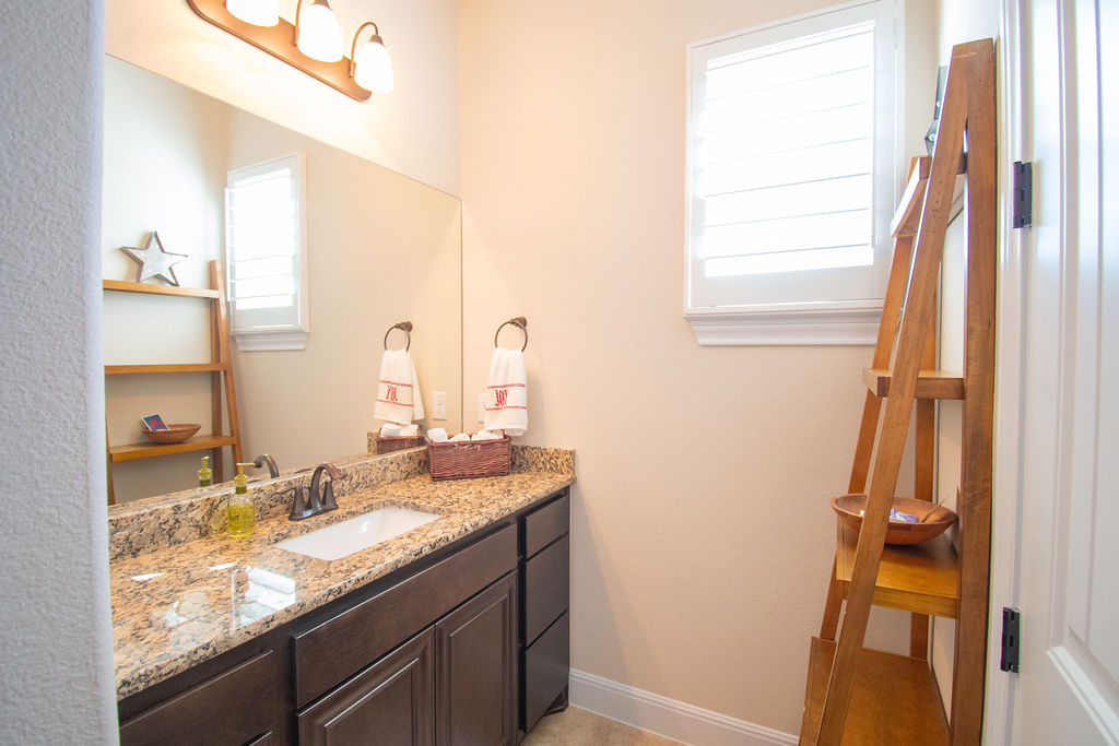 Undisclosed Address Georgetown, TX 78633 - Photo 14 of 39 a bathroom with a granite countertop sink and a mirror