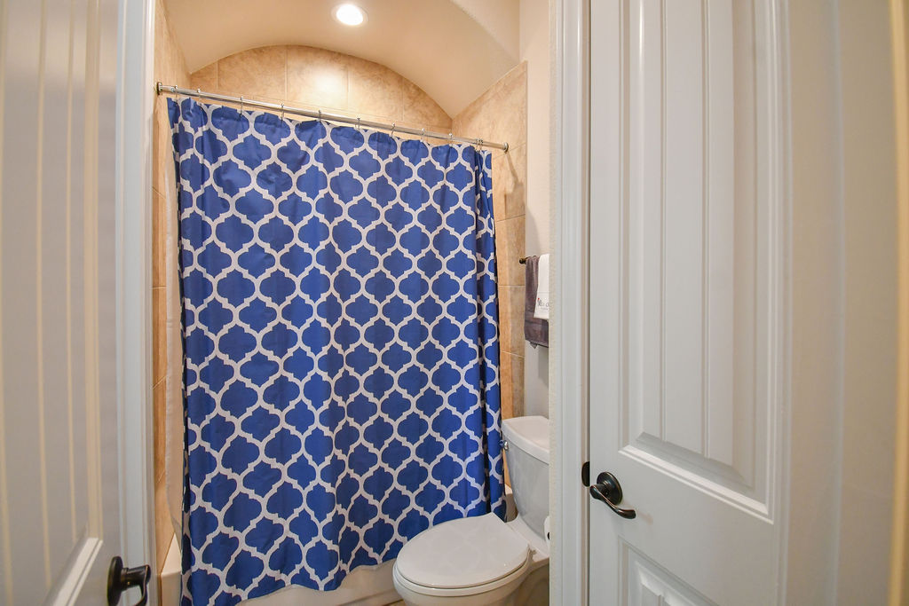 Undisclosed Address Georgetown, TX 78633 - Photo 15 of 39 a bathroom with a toilet and a shower curtain