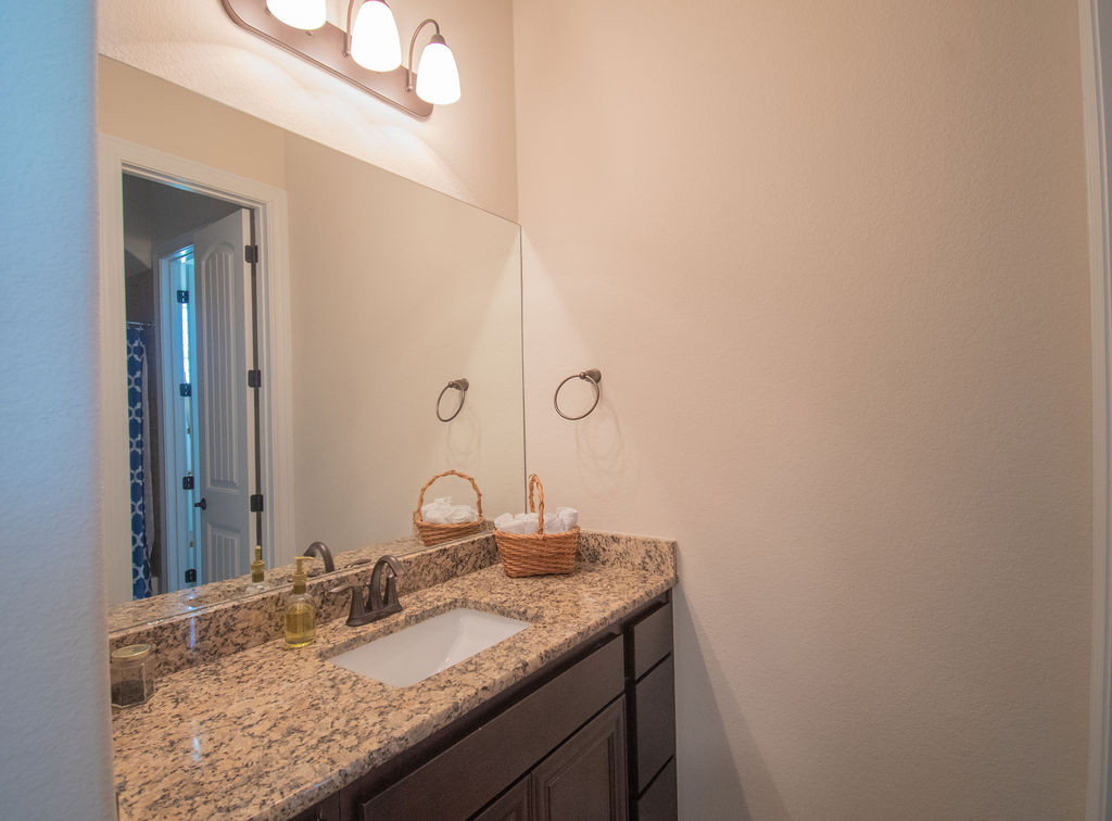 Undisclosed Address Georgetown, TX 78633 - Photo 16 of 39 a bathroom with a granite countertop sink and a mirror