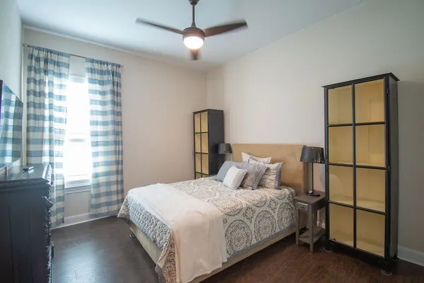 a bedroom with a large bed and a chandelier