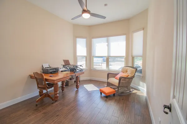 a workspace with wooden floor and a window
