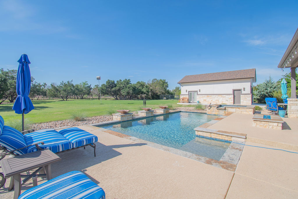 Undisclosed Address Georgetown, TX 78633 - Photo 26 of 39 a view of a backyard with swimming pool