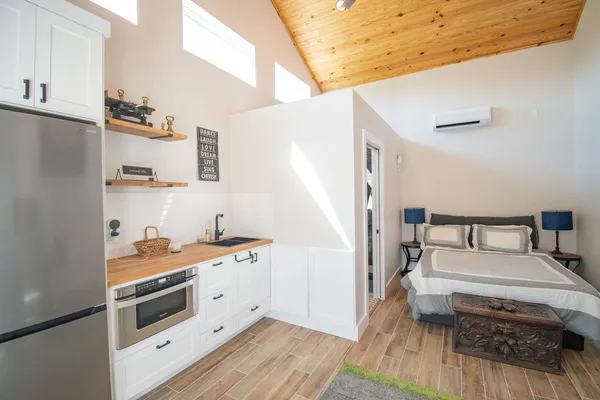 a kitchen with a sink and wooden floor