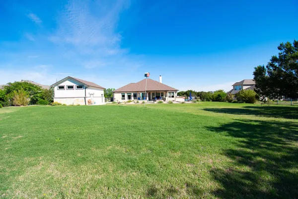 a backyard of a house with lots of green space and garden view