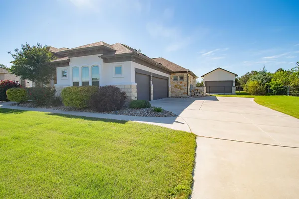 a front view of a house with a yard and garage