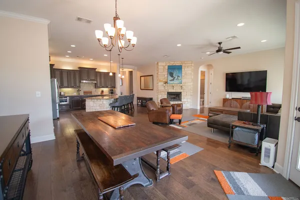 a living room with furniture a chandelier and a flat screen tv