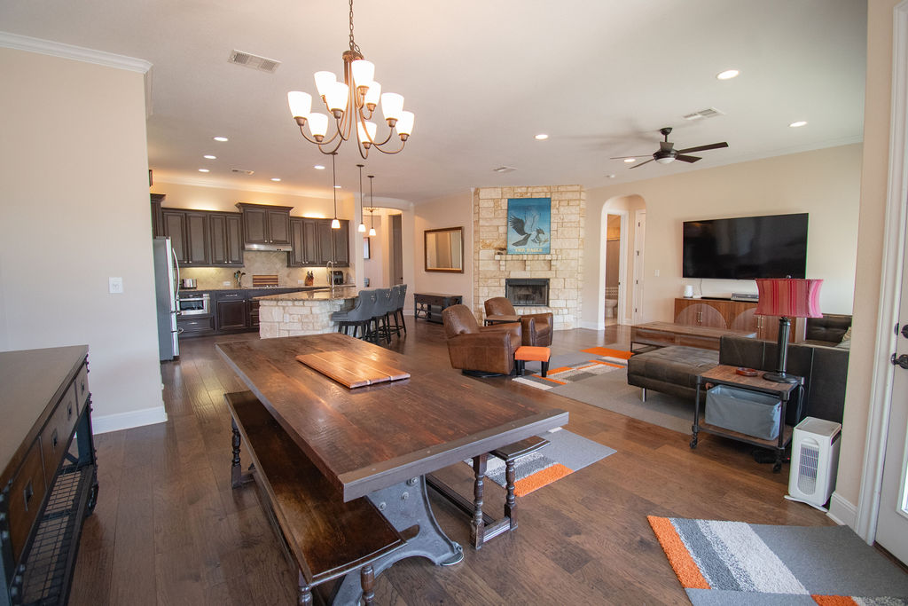Undisclosed Address Georgetown, TX 78633 - Photo 6 of 39 a living room with furniture a chandelier and a flat screen tv