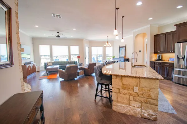 a large kitchen with a table and chairs