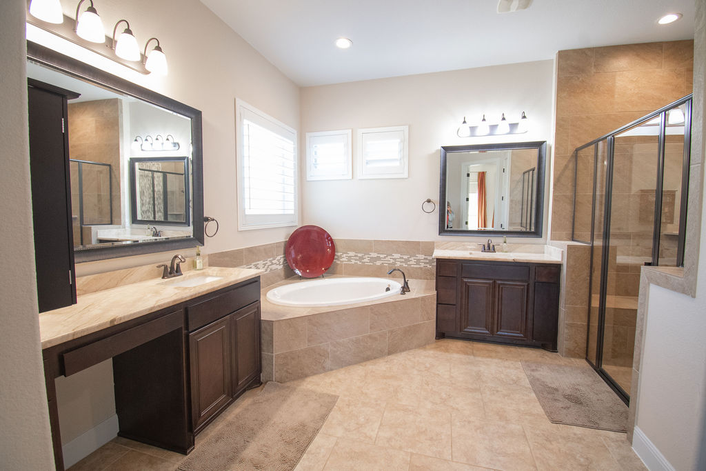 Undisclosed Address Georgetown, TX 78633 - Photo 10 of 39 a spacious bathroom with a sink double vanity granite tub shower and a mirror
