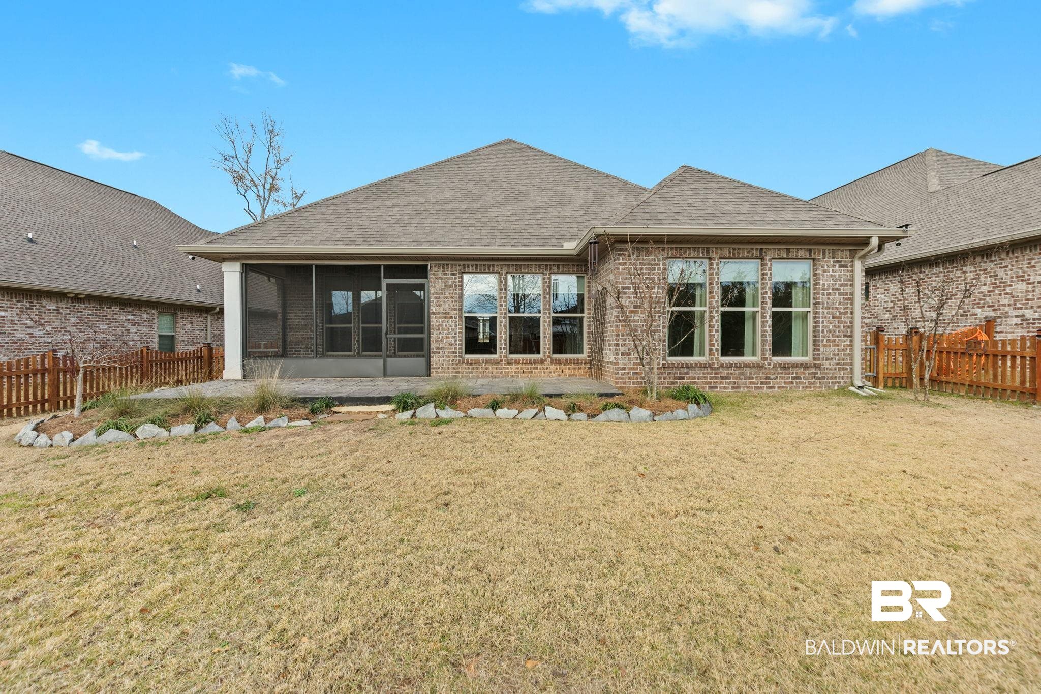 31654 Canopy Loop Daphne, AL 36527 - Photo 51 of 64 Back of property with a sunroom, a fenced backyard, roof with shingles, and brick siding