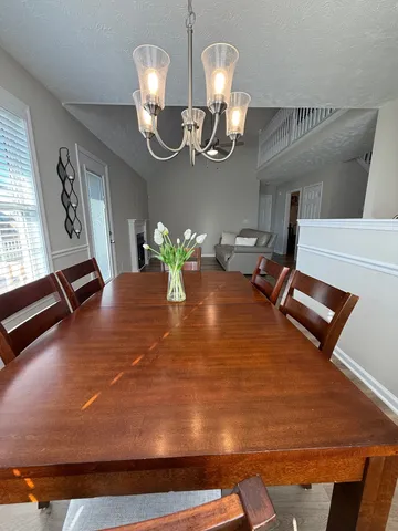 a living room with furniture and a chandelier