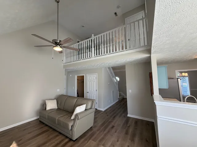 a view of a livingroom with furniture and a window