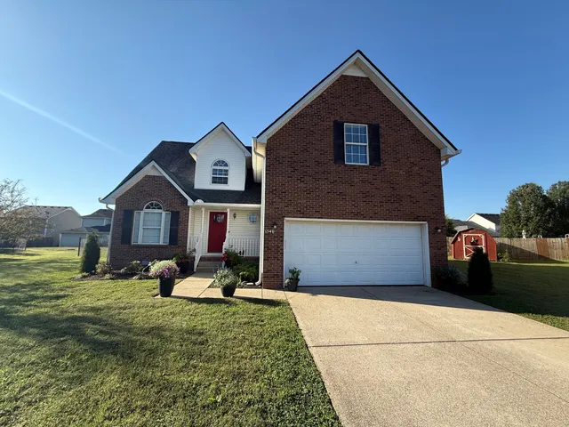 a front view of a house with a yard and garage