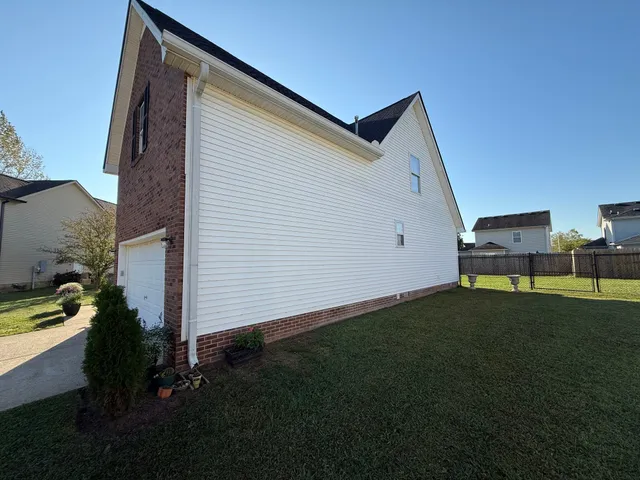 a backyard of a house with table and chairs