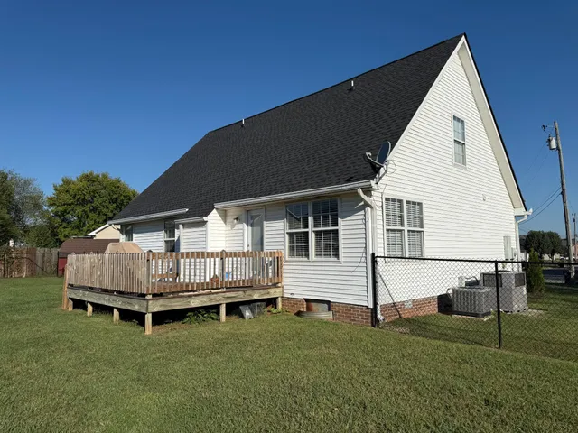 a view of backyard with deck and garden