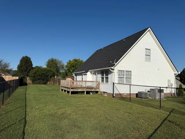 a view of a white house with a yard