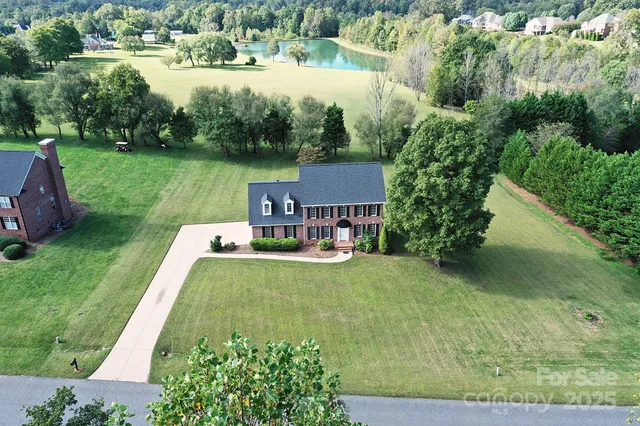 an aerial view of a house with yard swimming pool and outdoor seating