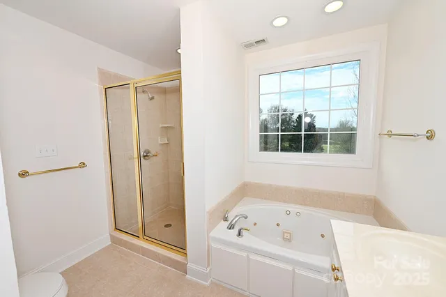 a bathroom with a bathtub and a window