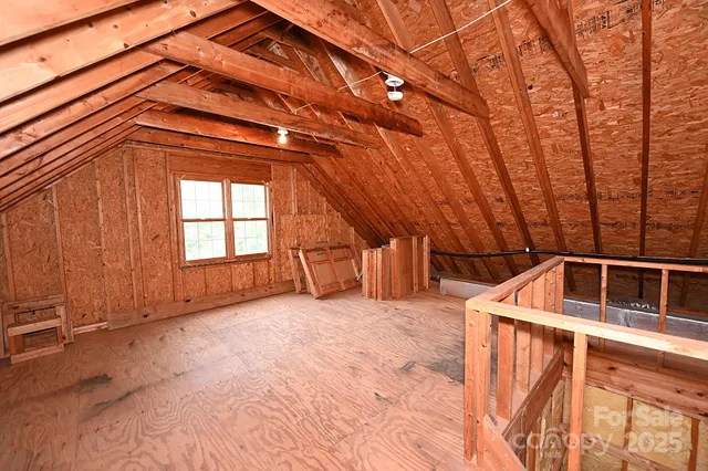 an aerial view of a house with garden space and trees all around