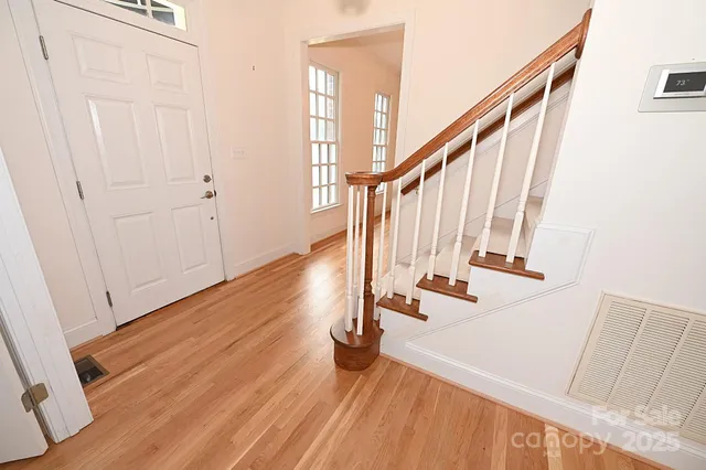 a view of an entryway with wooden floor
