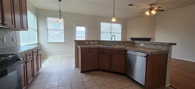 a kitchen with a stove sink and cabinets