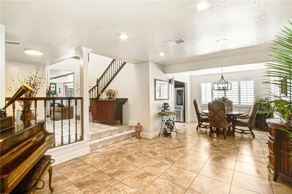 a lobby with furniture and a potted plant