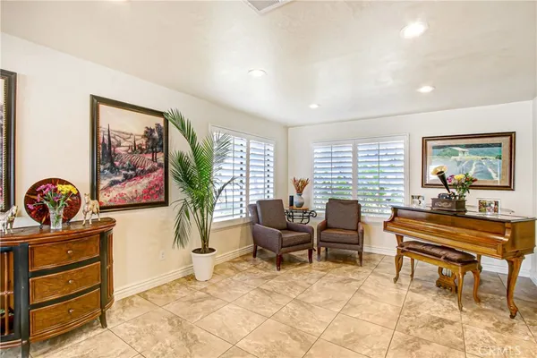 a living room with furniture and a piano table