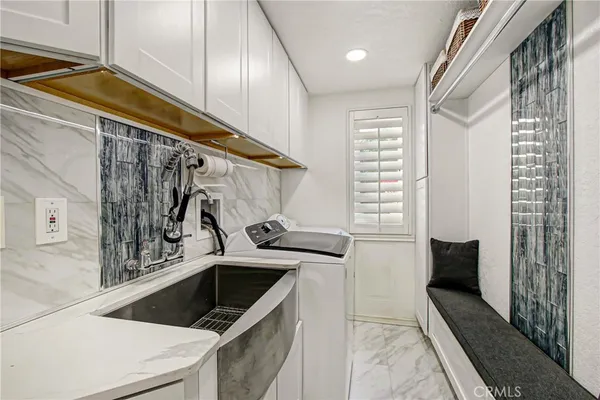 a kitchen that has a sink and a stove