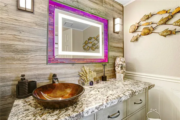 a bathroom with a granite countertop sink and a mirror