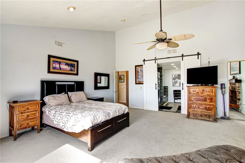 9111 Hidden Farm Road Alta Loma, CA 91737 - Photo 21 of 45 a bedroom with a bed and a flat screen tv