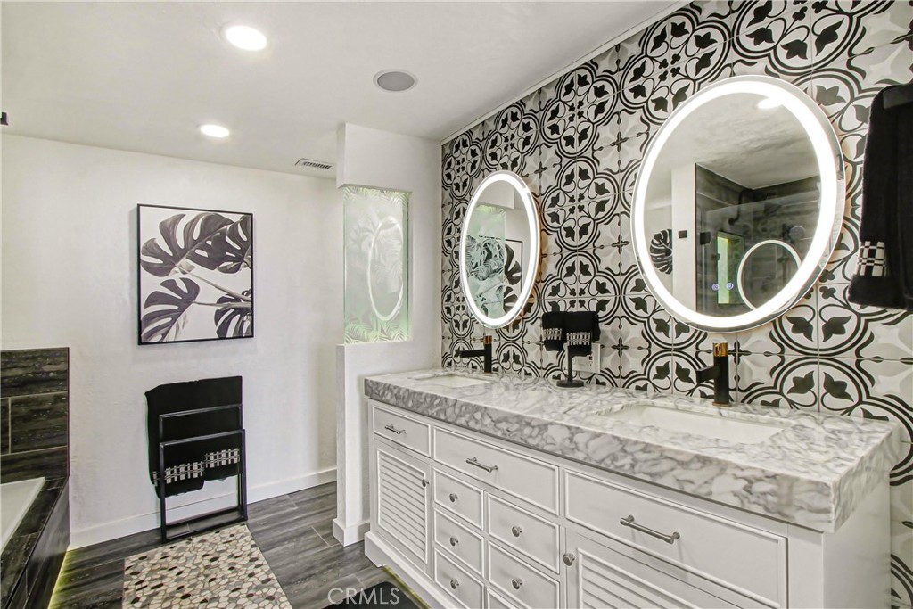 9111 Hidden Farm Road Alta Loma, CA 91737 - Photo 22 of 45 a bathroom with a granite countertop sink and a mirror