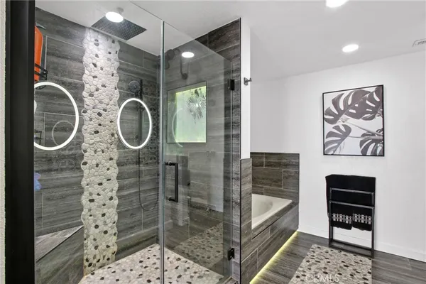 a bathroom with a shower a mirror and a sink