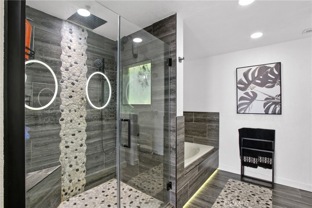 9111 Hidden Farm Road Alta Loma, CA 91737 - Photo 23 of 45 a bathroom with a shower a mirror and a sink