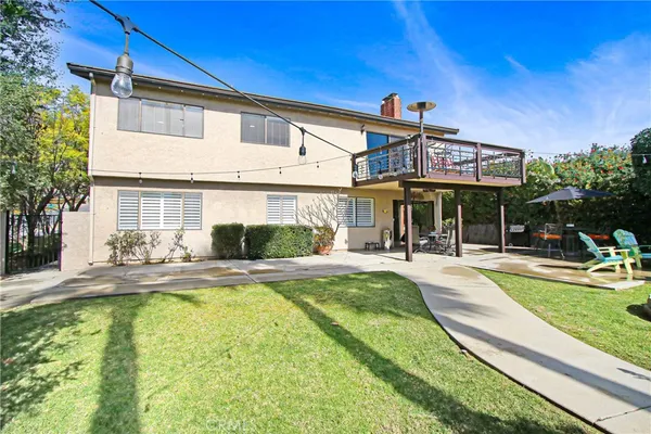 a view of a house with swimming pool and sitting area