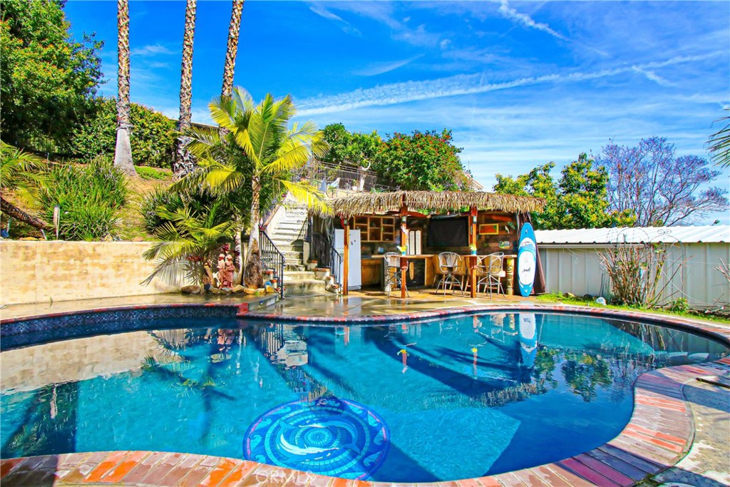 9111 Hidden Farm Road Alta Loma, CA 91737 - Photo 33 of 45 a view of a swimming pool with a patio