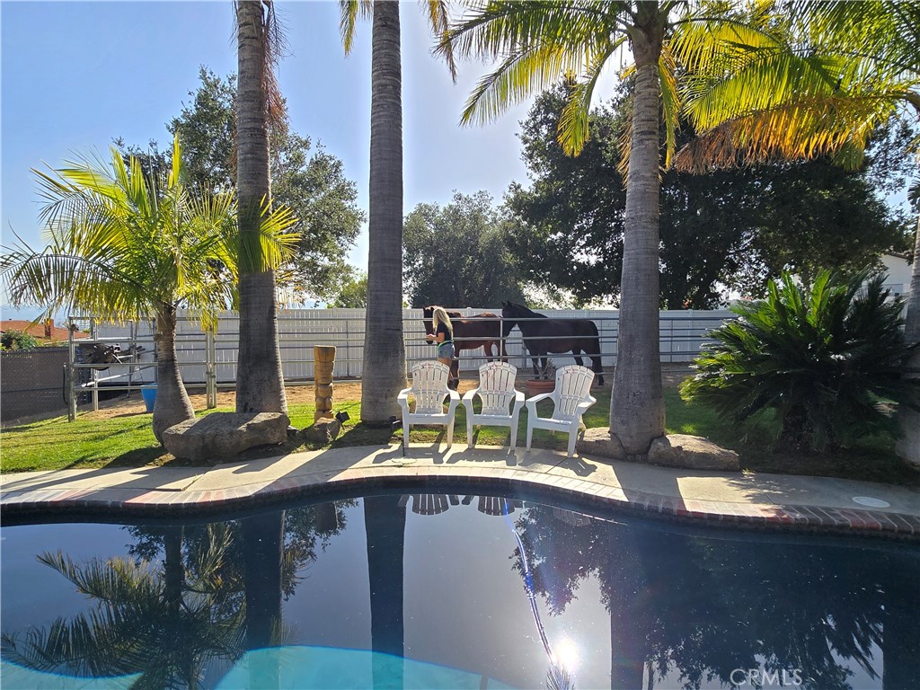 9111 Hidden Farm Road Alta Loma, CA 91737 - Photo 34 of 45 a view of a table and chairs in patio with a lake view