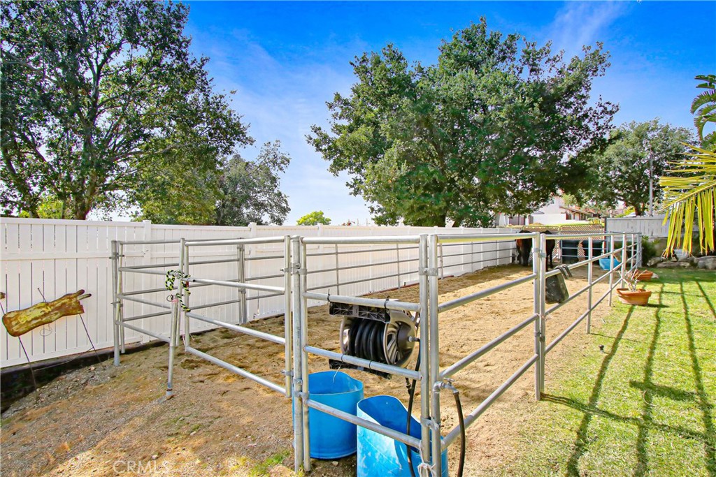 9111 Hidden Farm Road Alta Loma, CA 91737 - Photo 35 of 45 a view of a balcony with chairs and wooden fence