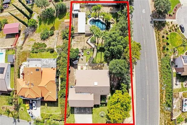 an aerial view of residential houses with yard