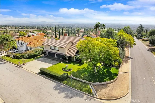 an aerial view of a house with a yard