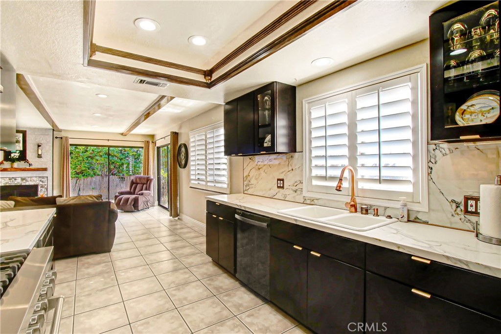 9111 Hidden Farm Road Alta Loma, CA 91737 - Photo 8 of 45 a large kitchen with a large window and stainless steel appliances