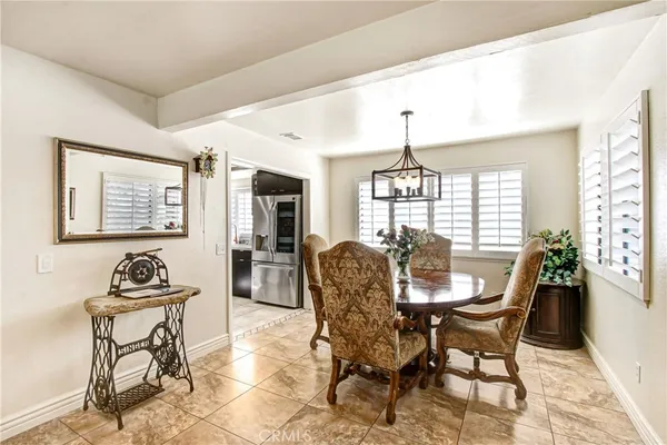 a dining room with furniture a chandelier and wooden floor