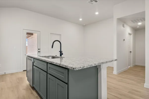 a kitchen with a sink and a hard wood floor