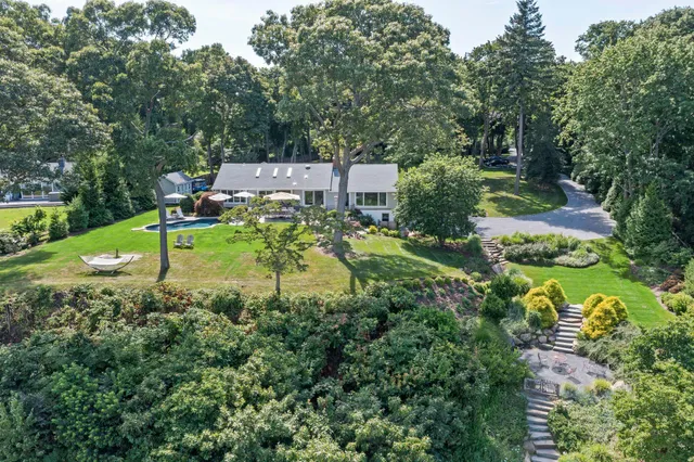 a view of a house with swimming pool and sitting area