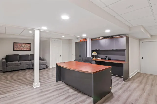a bathroom with a granite countertop toilet sink and mirror