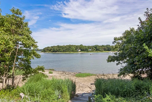 a view of a house with backyard porch and sitting area